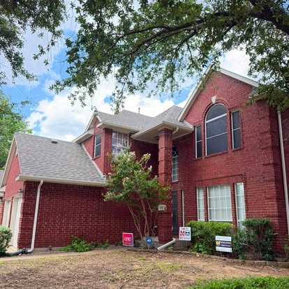 Red brick North Texas home with a completed Fireman's Roofing shingle roof