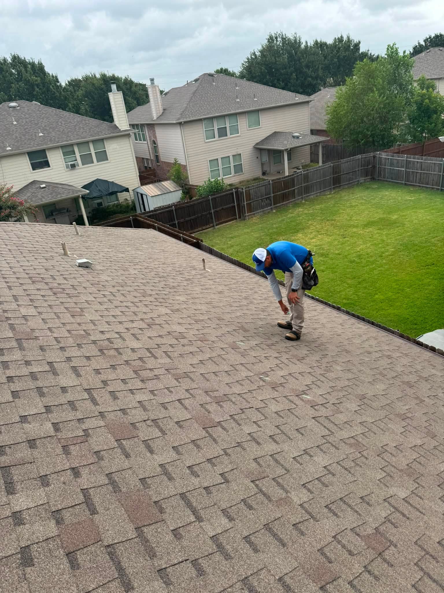 Fireman's Roofing owner inspecting a Melissa area roof for hail and storm damage
