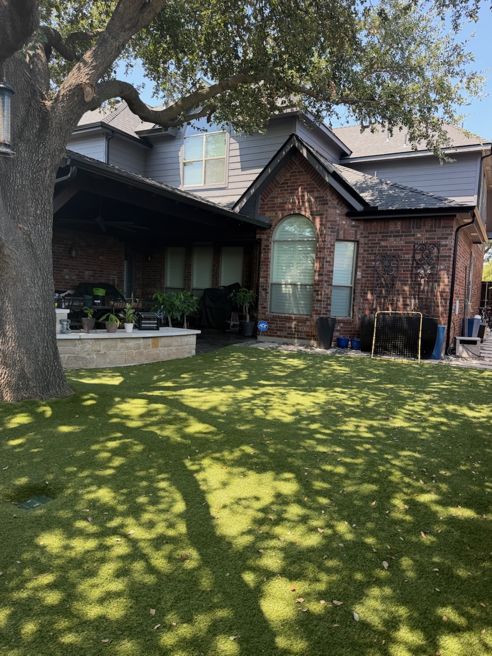 Rear elevation window replacement beside a covered patio on a McKinney, TX home