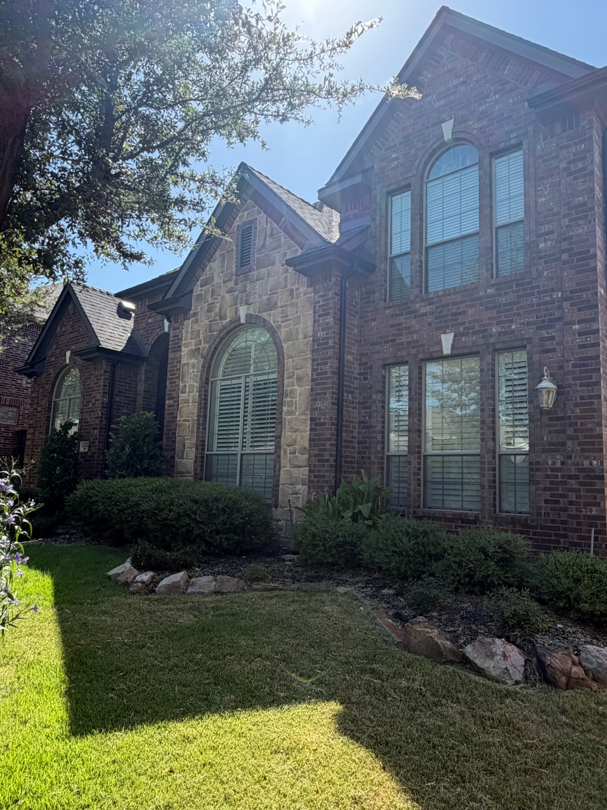 Two-story window stack and arched windows after replacement on a McKinney, TX home